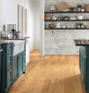 Kitchen with green cabinets and teak colored vinyl flooring