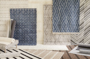 Stack of blue and gray textured and patterned small area rugs