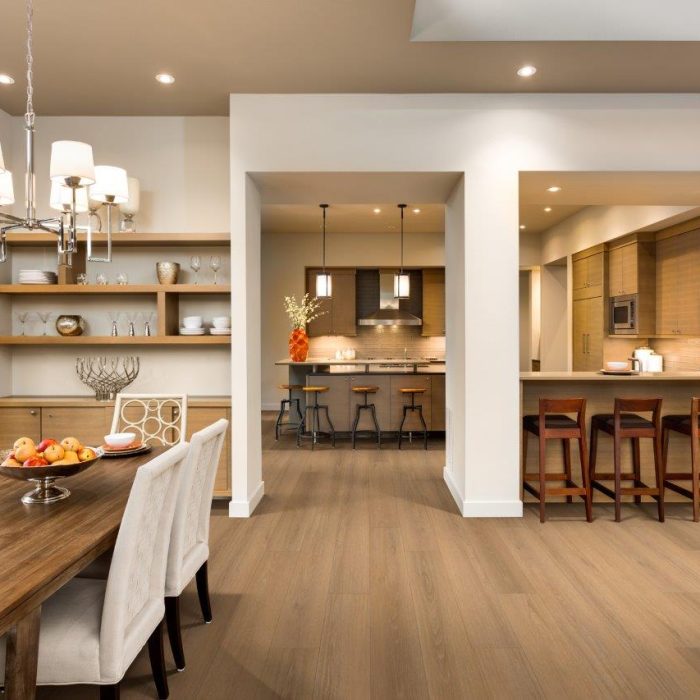 Open concept dining room and kitchen with teak colored hardwood flooring